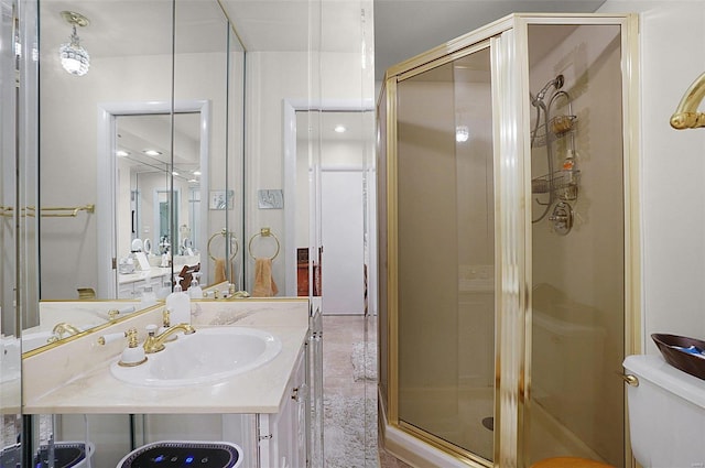 bathroom featuring toilet, vanity, and walk in shower