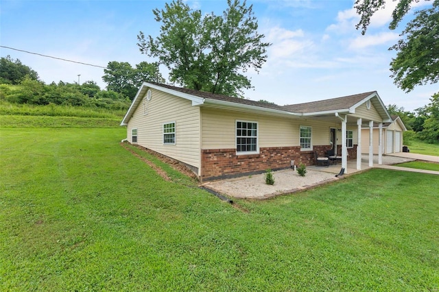 view of front facade with a garage, a patio, and a front yard