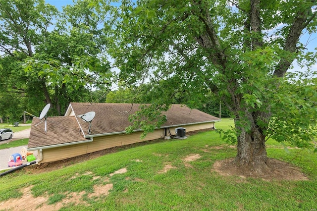 exterior space with a yard and central air condition unit