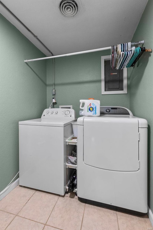 washroom with separate washer and dryer and light tile patterned flooring