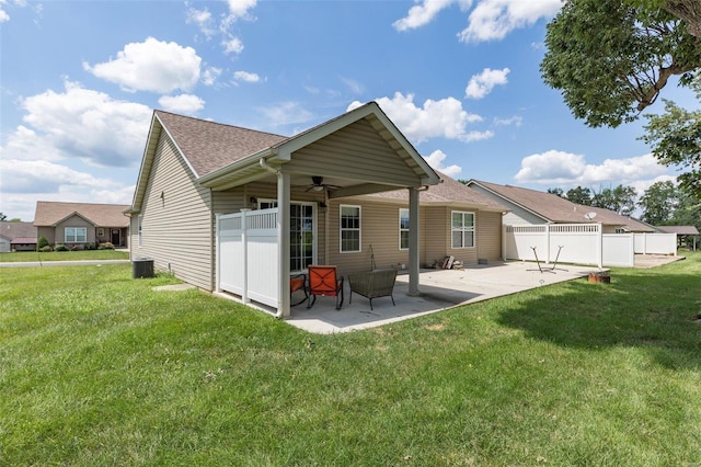 rear view of house with ceiling fan, central AC, a lawn, and a patio area