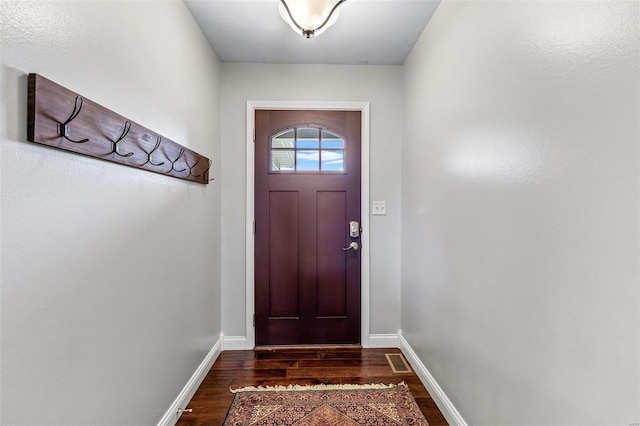 doorway to outside featuring dark wood-type flooring