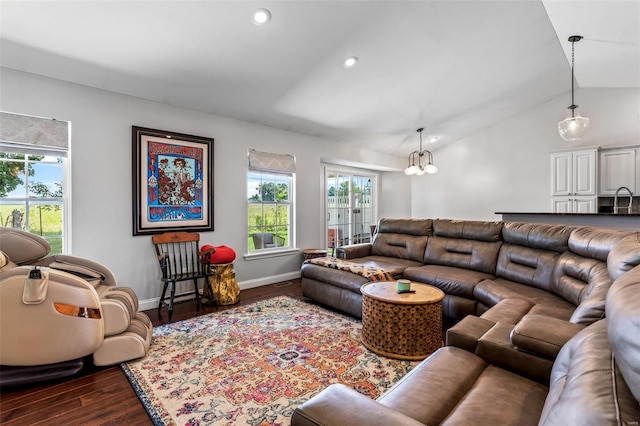 living room with lofted ceiling, dark wood-type flooring, sink, and a notable chandelier