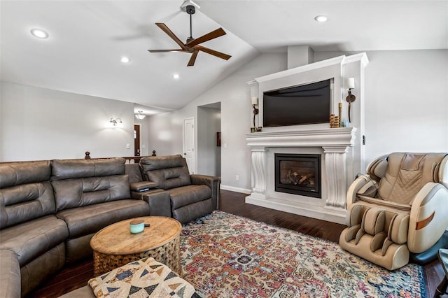 living room with ceiling fan, dark hardwood / wood-style floors, and vaulted ceiling