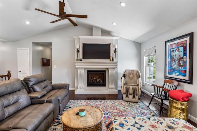 living room featuring lofted ceiling with beams, wood-type flooring, and a fireplace