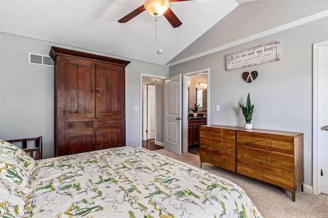 carpeted bedroom with ceiling fan, connected bathroom, and vaulted ceiling