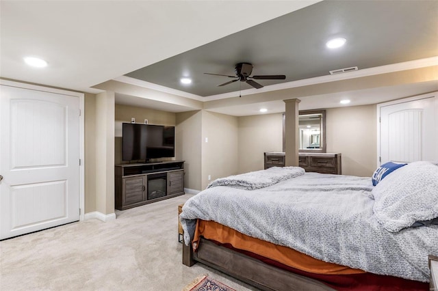 bedroom with light carpet, ceiling fan, crown molding, and a raised ceiling