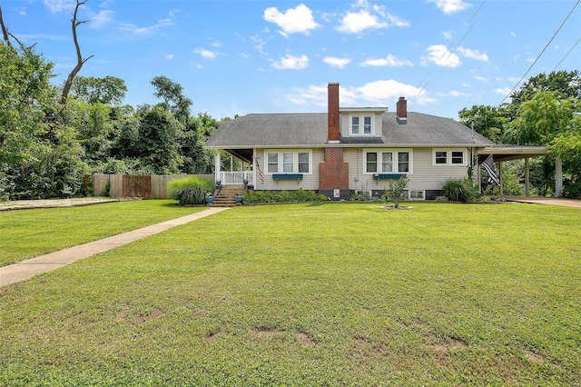 view of front of house with a front lawn and a carport