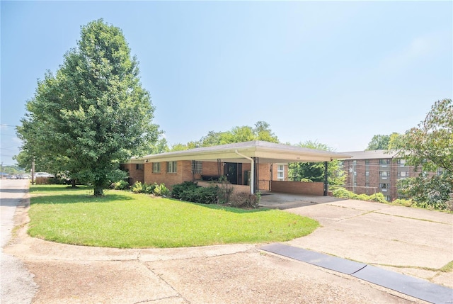 ranch-style house featuring a carport and a front yard