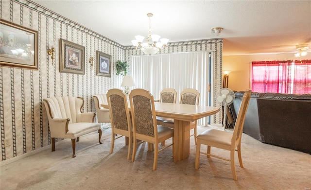 carpeted dining room featuring an inviting chandelier