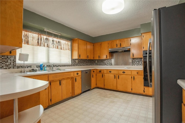 kitchen featuring sink, decorative backsplash, appliances with stainless steel finishes, and light tile patterned floors