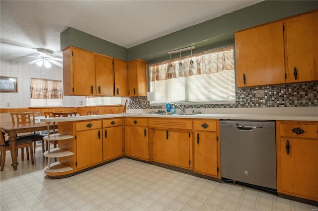 kitchen with light tile patterned flooring, ceiling fan, tasteful backsplash, sink, and dishwasher