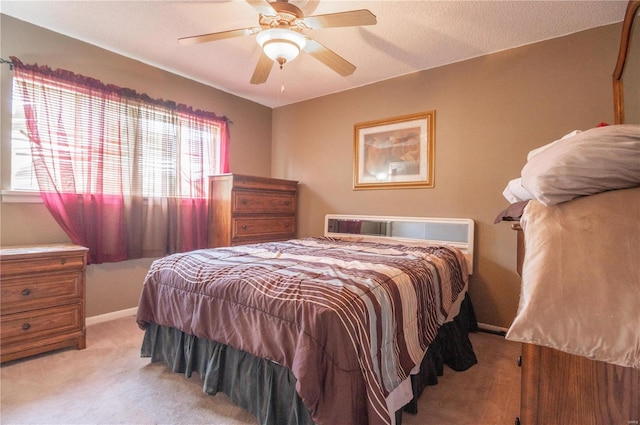 bedroom featuring light carpet, multiple windows, and ceiling fan