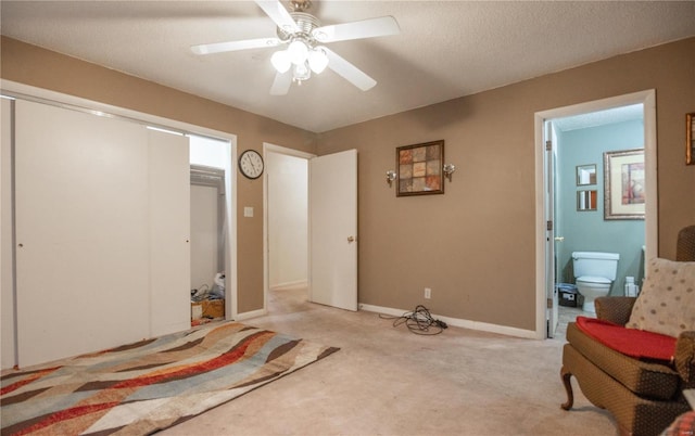 sitting room with a textured ceiling, ceiling fan, and light colored carpet