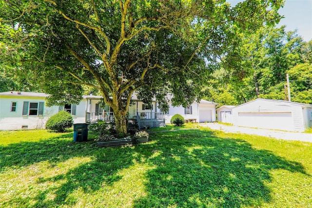 view of front of property with a garage, an outdoor structure, and a front lawn