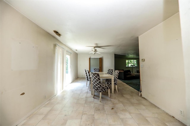 tiled dining room featuring ceiling fan