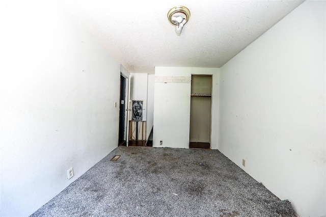 unfurnished bedroom featuring carpet flooring and a textured ceiling