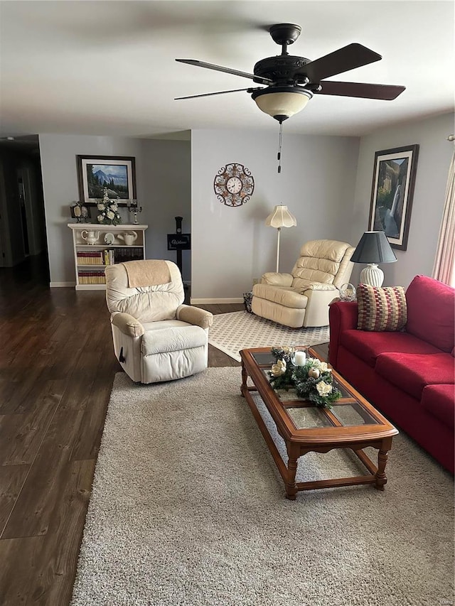 living room featuring dark wood-type flooring and ceiling fan