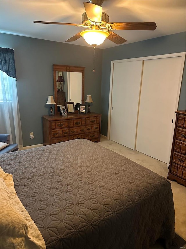 carpeted bedroom featuring a closet and ceiling fan