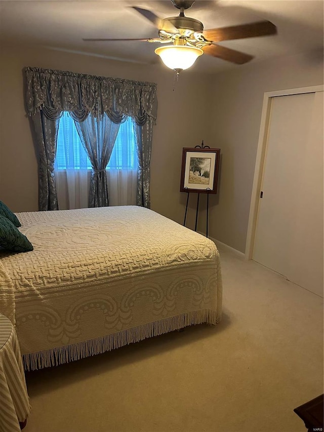 carpeted bedroom featuring ceiling fan