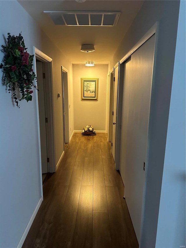 corridor featuring dark hardwood / wood-style floors