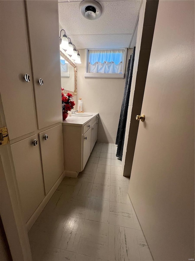 bathroom featuring tile patterned floors, curtained shower, a textured ceiling, and vanity