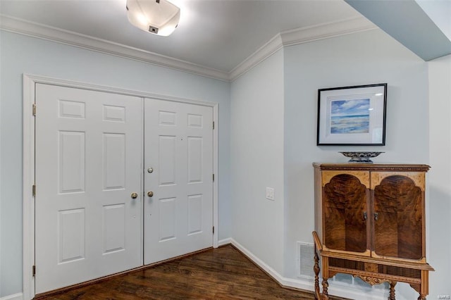 entrance foyer featuring dark hardwood / wood-style flooring and ornamental molding