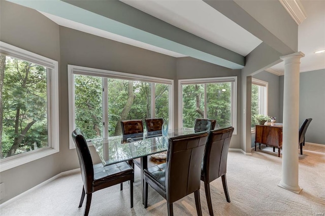 dining area featuring plenty of natural light, decorative columns, and light carpet