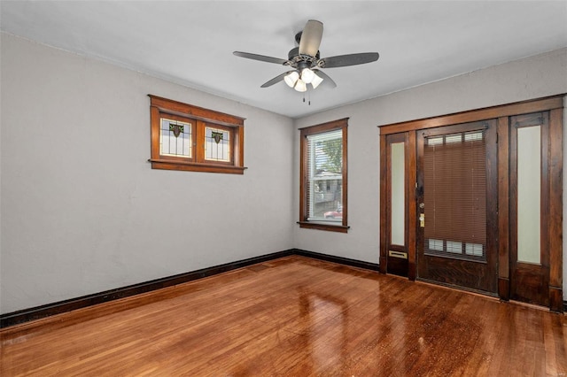 foyer with ceiling fan and wood-type flooring