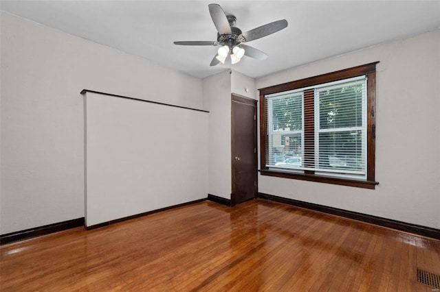 unfurnished bedroom with a closet, wood-type flooring, and ceiling fan