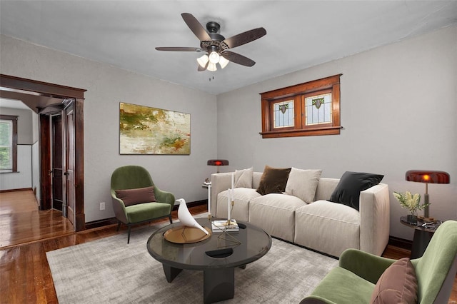 living room featuring ceiling fan and hardwood / wood-style floors