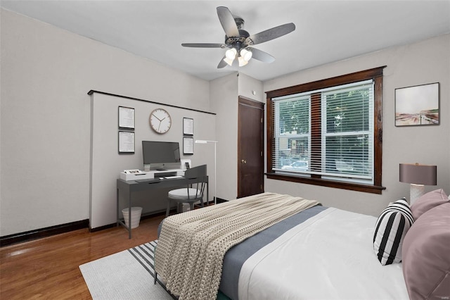 bedroom with wood-type flooring and ceiling fan