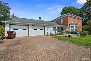 view of front of home with a garage and driveway