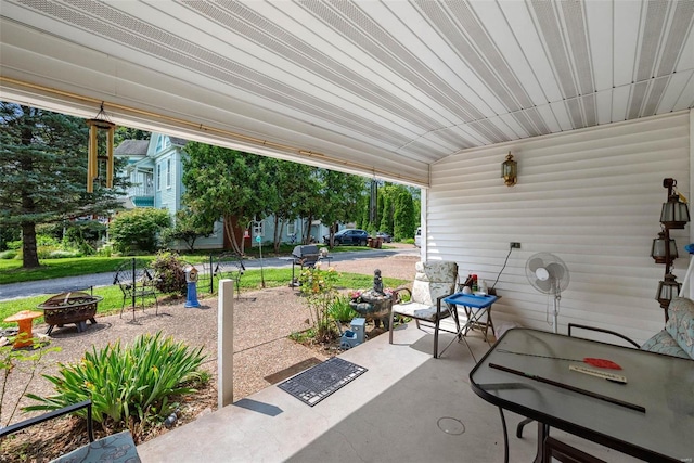 view of patio / terrace featuring an outdoor fire pit