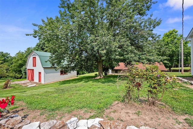 view of yard with a barn and an outdoor structure