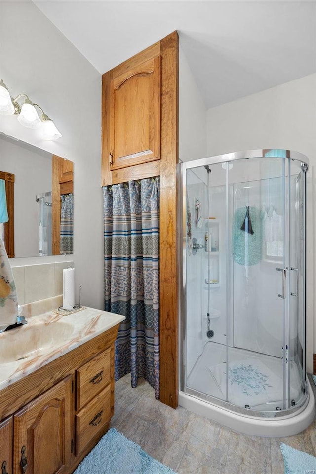 bathroom with a stall shower and vanity