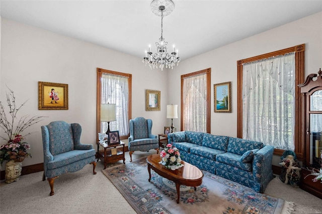 carpeted living area with a chandelier