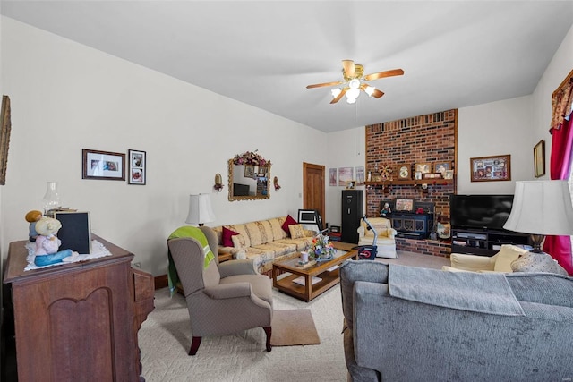 living room with a wood stove, light carpet, and ceiling fan