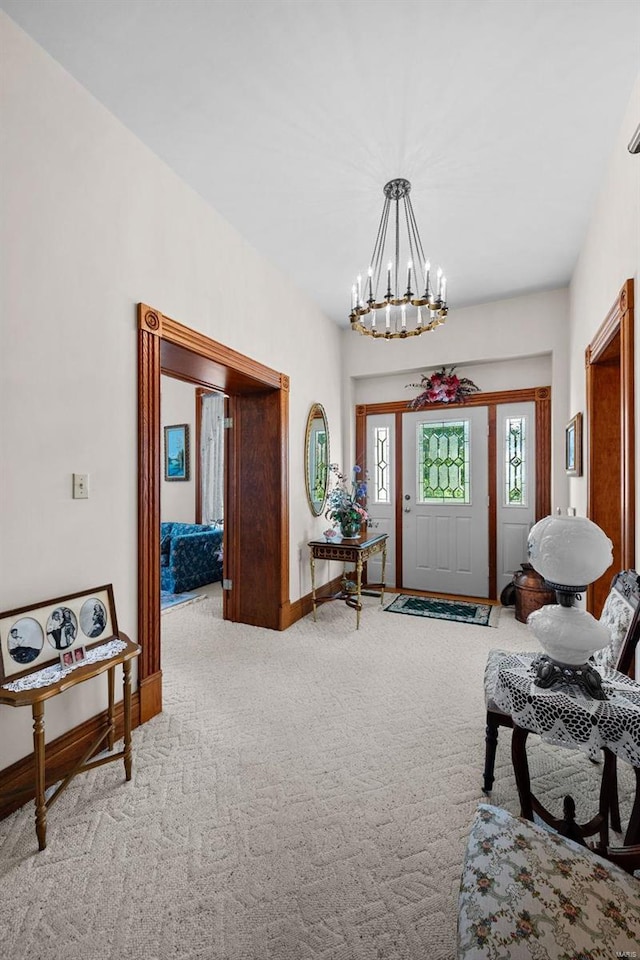 foyer entrance featuring light carpet, baseboards, and an inviting chandelier