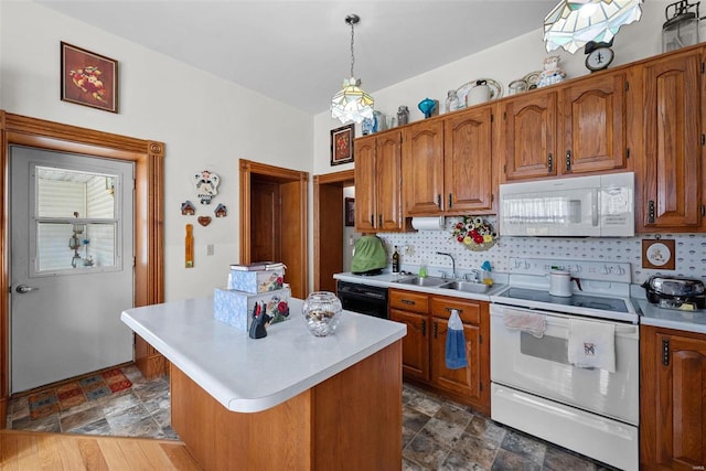 kitchen with white appliances, light countertops, hanging light fixtures, brown cabinets, and a center island