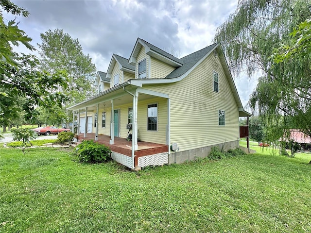 view of side of property featuring a yard and a porch