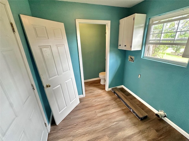 bathroom featuring wood-type flooring and toilet