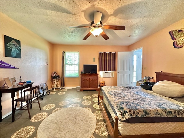 bedroom featuring cooling unit, ceiling fan, and a textured ceiling