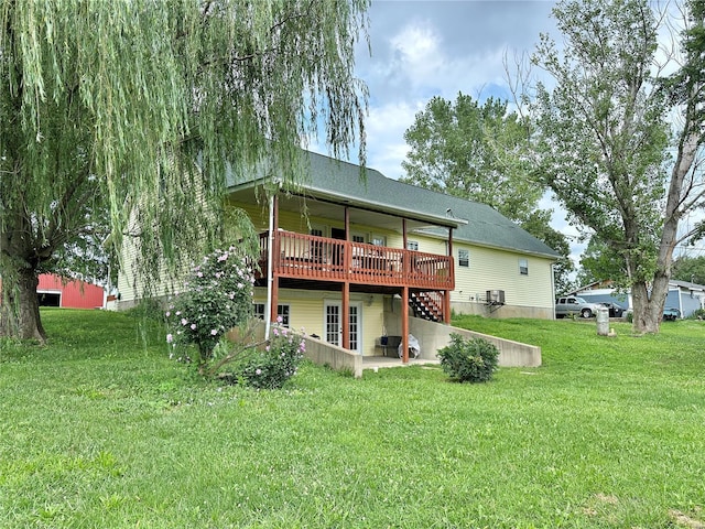 back of house featuring a patio area, a lawn, and a deck