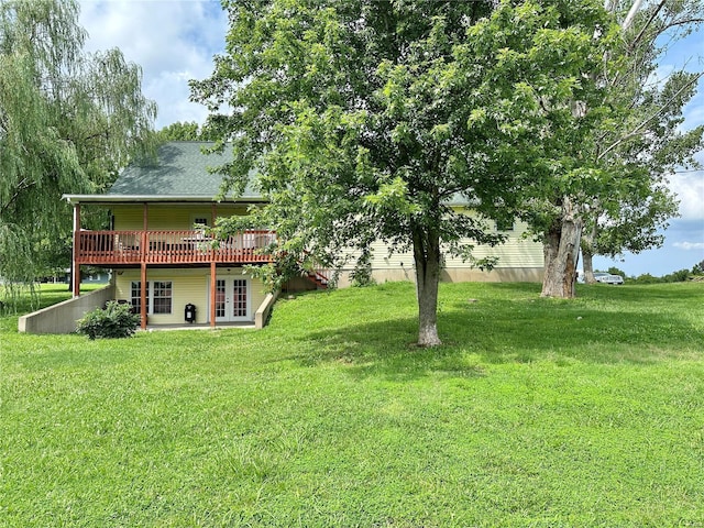 view of yard featuring a wooden deck and french doors