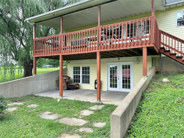 rear view of house featuring a patio, french doors, and a deck