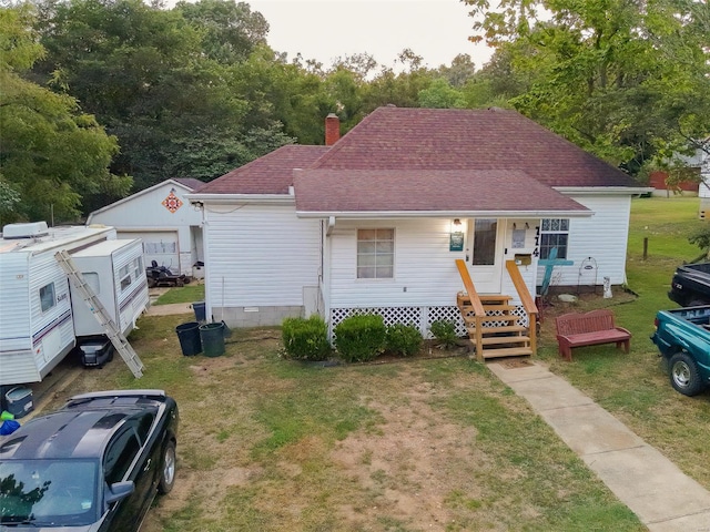 view of front of home featuring covered porch and a front yard