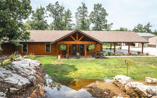 cabin featuring a patio area and a front yard