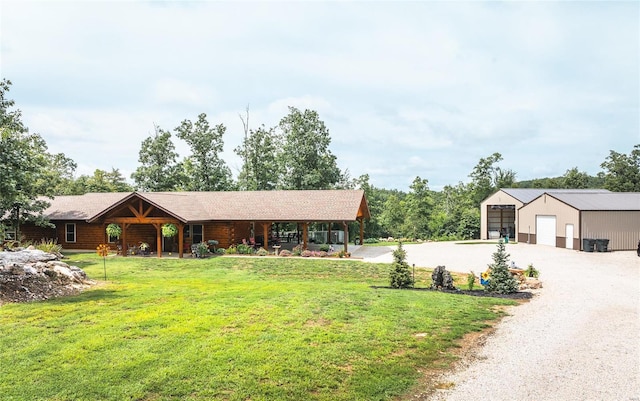 view of front facade featuring a garage, an outdoor structure, and a front yard