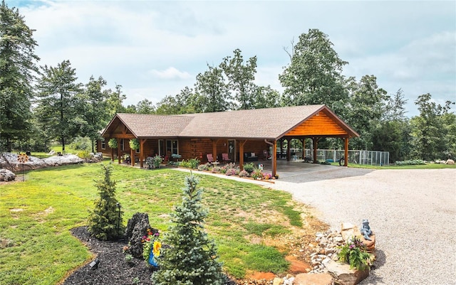 view of front of property with a carport and a front lawn